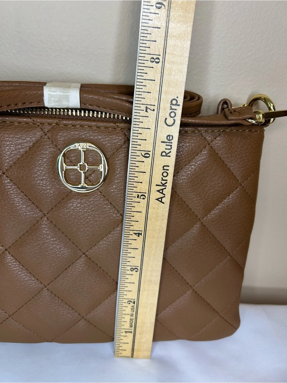 IMAN Quilted Tan Crossbody with Gold Medallion
